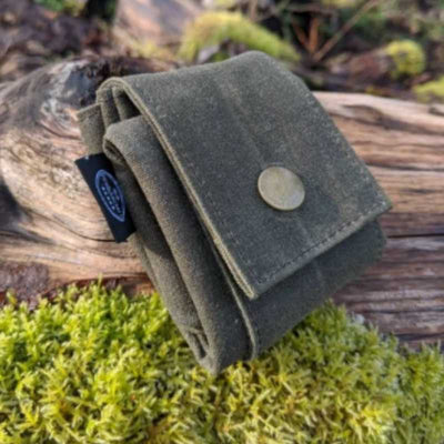 waxed canvas foraging pouch with moss and wood