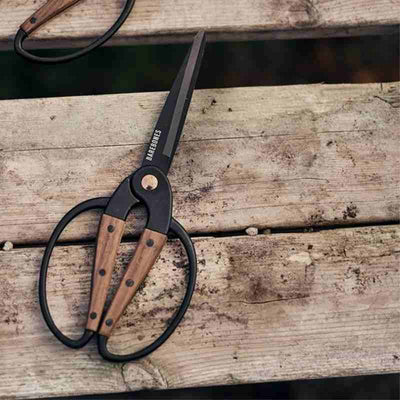 gardening scissors on wooden table 