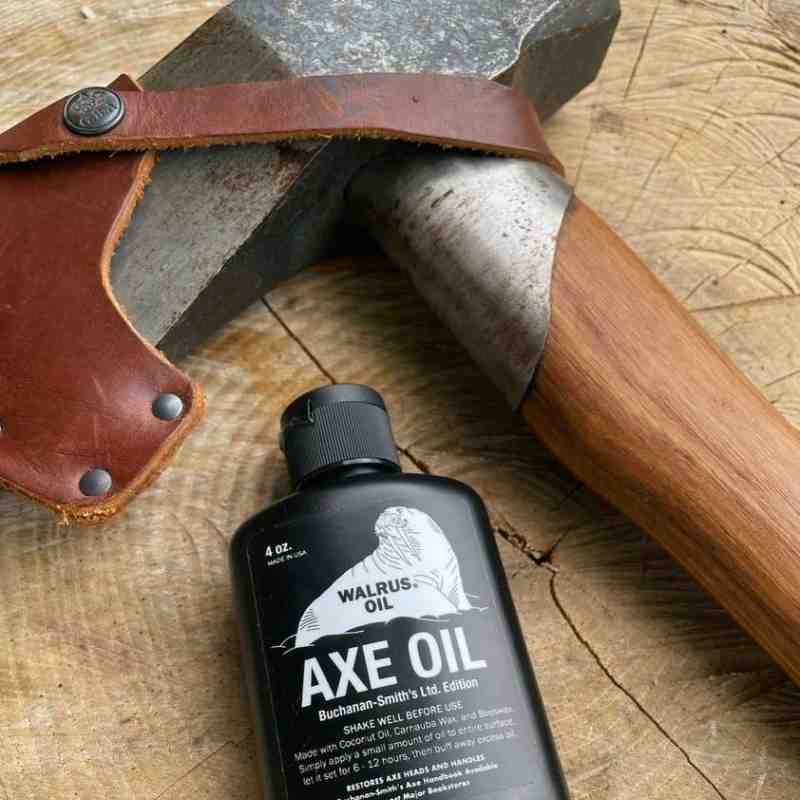 Walrus axe oil on log with an axe